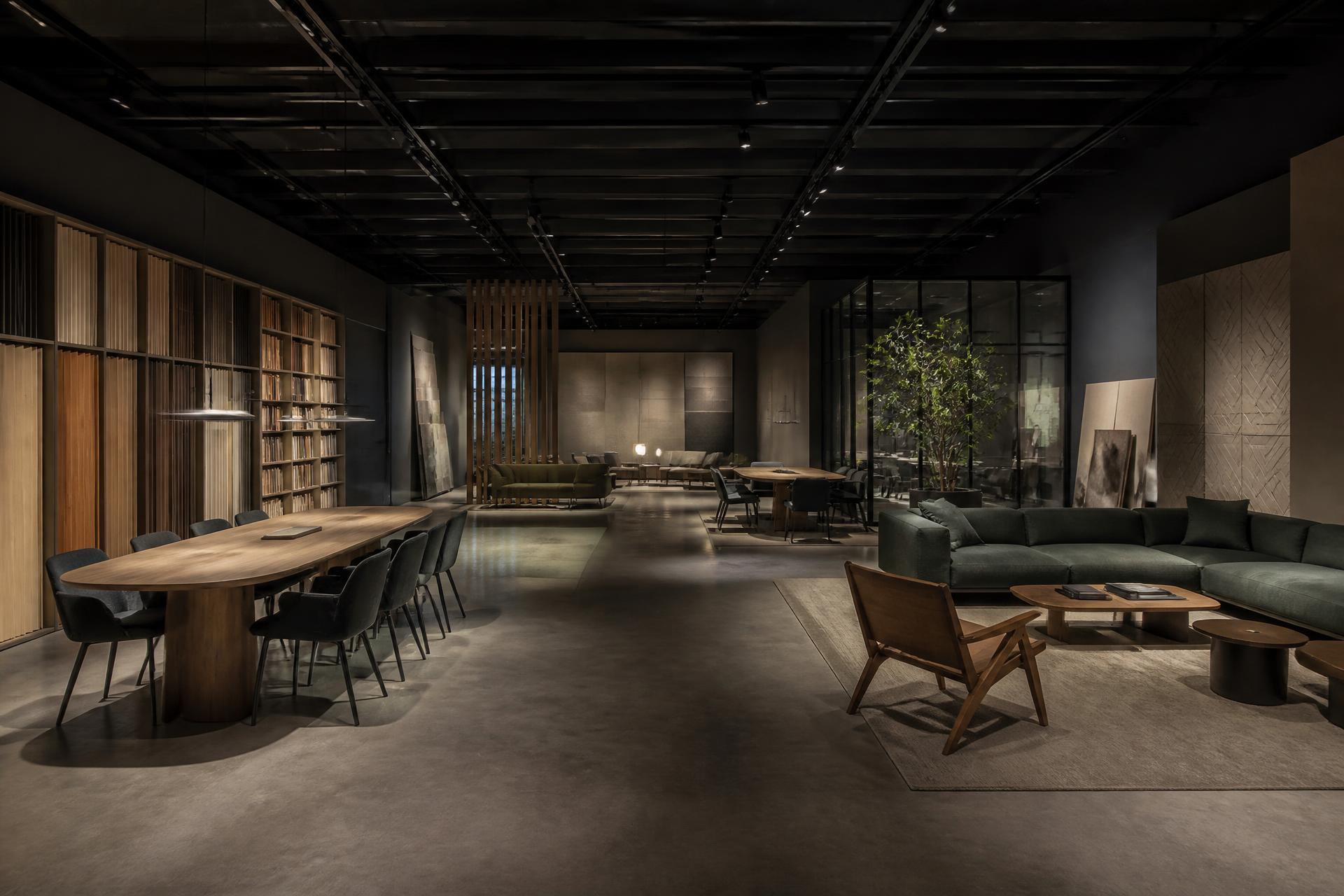 Wide establishing view of a high-end furniture showroom with architectural interiors